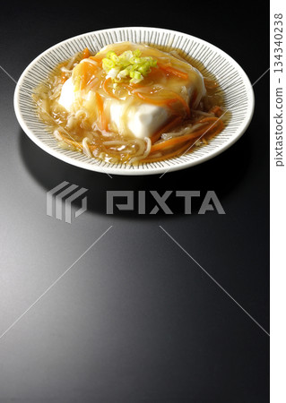 Silken tofu with thick bean paste photographed against a black background 134340238