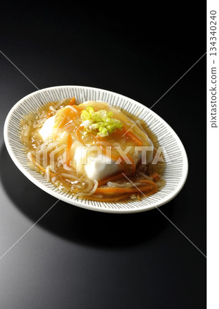 Silken tofu with thick bean paste photographed against a black background 134340240