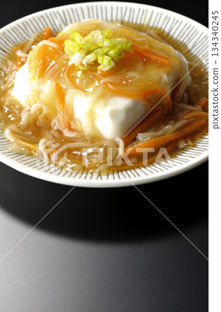 Silken tofu with thick bean paste photographed against a black background 134340245