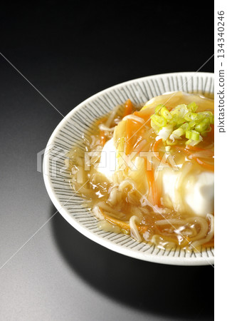 Silken tofu with thick bean paste photographed against a black background 134340246