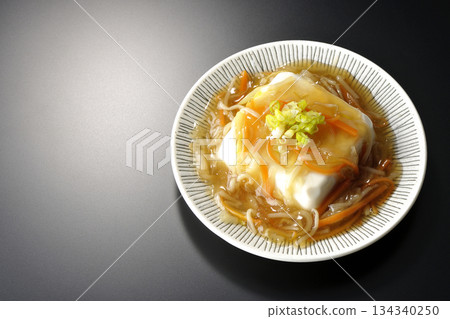 Silken tofu with thick bean paste photographed against a black background 134340250