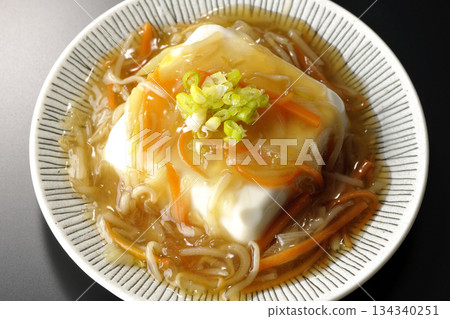 Silken tofu with thick bean paste photographed against a black background 134340251