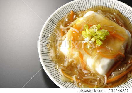 Silken tofu with thick bean paste photographed against a black background Silken tofu with thick bean paste photographed against a black background 134340252