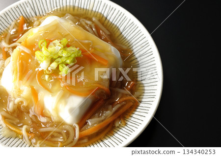 Silken tofu with thick bean paste photographed against a black background 134340253