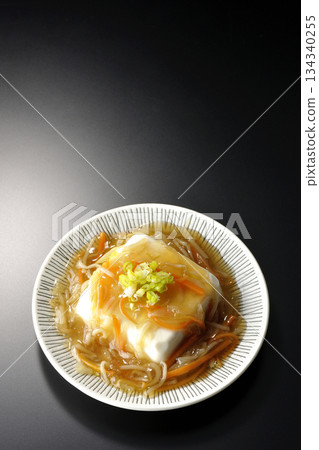 Silken tofu with thick bean paste photographed against a black background 134340255