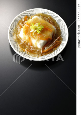 Silken tofu with thick bean paste photographed against a black background 134340256