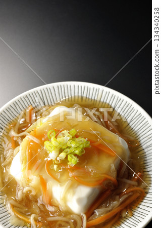 Silken tofu with thick bean paste photographed against a black background 134340258