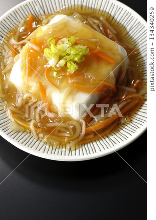 Silken tofu with thick bean paste photographed against a black background Silken tofu with thick bean paste photographed against a black background 134340259