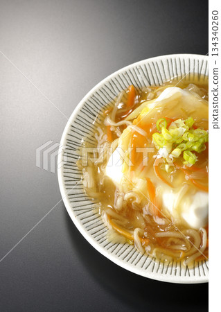 Silken tofu with thick bean paste photographed against a black background 134340260