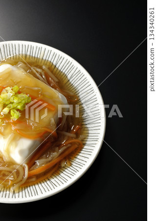 Silken tofu with thick bean paste photographed against a black background 134340261