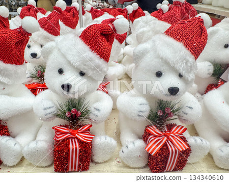 Cute White Teddy Bears Wearing Santa Hats with Christmas Gift Boxes 134340610