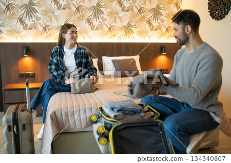 Young couple unpacking after arrival to the hotel for vacation 134340807