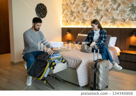 Young couple unpacking after arrival to the hotel for vacation 134340808