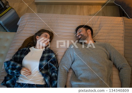 Young couple lying on the bed in a hotel room and feeling relaxed 134340809
