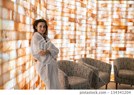 Pretty woman in white bath robe feeling relaxed and peaceful after spa procedures Pretty woman in white bath robe feeling relaxed and peaceful after spa procedures 134341204