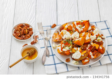 baked butternut squash with cheese, thyme, pecan baked butternut squash with cheese, thyme, pecan 134341756