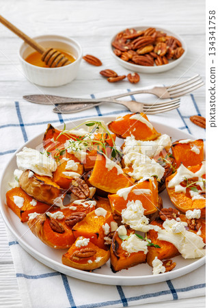 baked butternut squash with cheese, thyme, pecan baked butternut squash with cheese, thyme, pecan 134341758