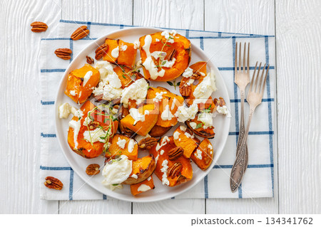 baked butternut squash with cheese, thyme, pecan 134341762