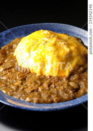 Omelet curry rice photographed against a black background 134342146