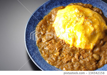 Omelet curry rice photographed against a black background 134342158