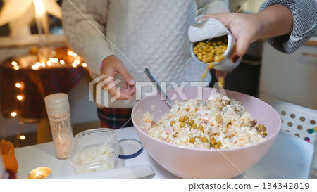 Carefully combining ingredients into festive dish for joyful gathering Carefully combining ingredients into festive dish for joyful gathering 134342819