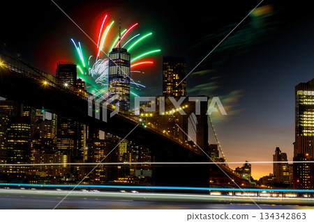Fireworks light up New York City skyline over Brooklyn Bridge during evening celebration 134342863