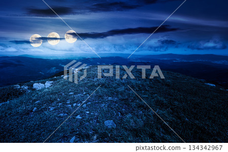grassy slopes with boulders of mountain at night. beautiful summer scenery of alpine green environment under sky with clouds in full moon light. finance investment or abstract concepts grassy slopes with boulders of mountain at night. beautiful summer scenery of alpine green environment under sky with clouds in full moon light. finance investment or abstract concepts 134342967