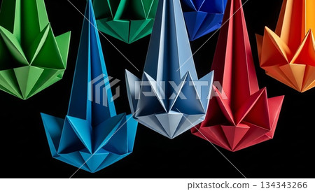 Colorful origami paper cranes hanging mobile display with geometric folded designs in rainbow spectrum against black background 134343266