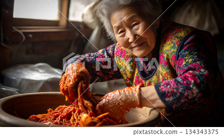 Middle-aged Woman Preparing Traditional Korean Kimchi in a Rustic Kitchen Setting for Authentic Cultural Experience 134343375