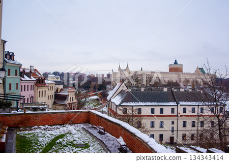 View of a city landscape with buildings and Lublin castle on a winter day View of a city landscape with buildings and Lublin castle on a winter day 134343414