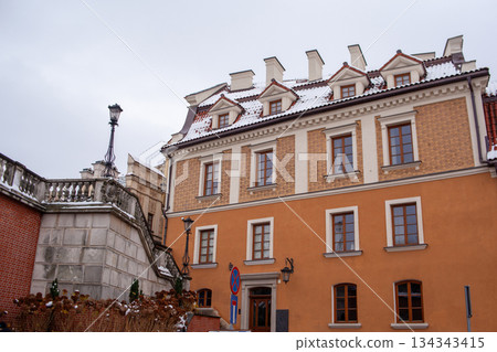 Historic building with snow on the roof in a city square during winter 134343415