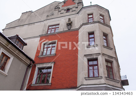 Building with a mix of brick and plaster in an urban setting during winter 134343463