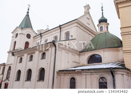 Church building with green dome in winter setting near city square Church building with green dome in winter setting near city square 134343482
