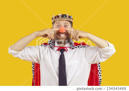 Happy funny office worker in costume of king and clown at corporate fancy dress party 134343489