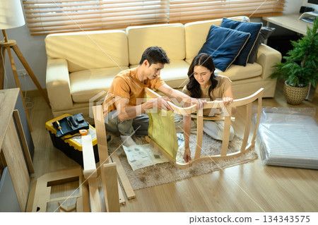 Photo series of young asian couple assembly a new furniture at home 134343575