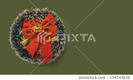 Festive Christmas wreath with red bow on green background and empty copy space Festive Christmas wreath with red bow on green background and empty copy space 134343638