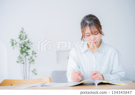 A young woman studying at home 134343847