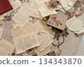 一張浪漫的餐桌照片，上面散落著一些古董紙片。 134343870