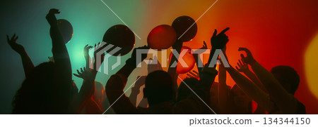Dancing silhouettes with balloons in colorful party atmosphere. Banner Dancing silhouettes with balloons in colorful party atmosphere. Banner 134344150