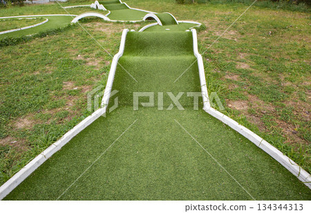 Mini golf hole with artificial turf and obstacles family fun horizontal 134344313