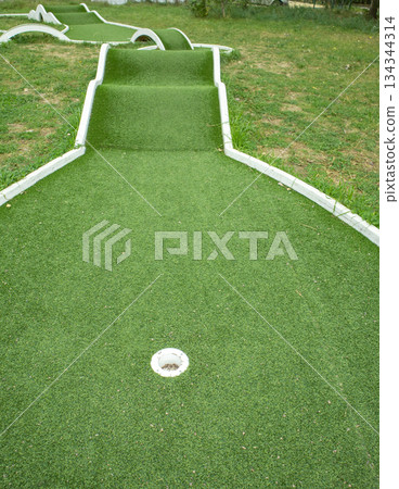 Mini golf lane with ramps and hole family leisure vertical 134344314