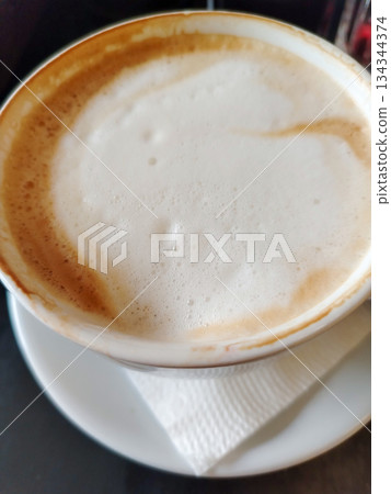 Cappuccino in cup top view rich milk foam vertical Cappuccino in cup top view rich milk foam vertical 134344374