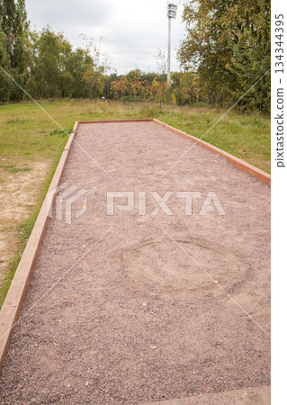 Petanque court on gravel in park vertical view Petanque court on gravel in park vertical view 134344395