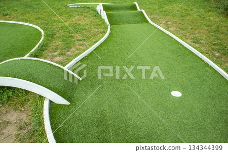 Mini golf lane with artificial turf and hole horizontal 134344399