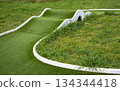 Mini golf lane with wavy hills and tunnel horizontal 134344418