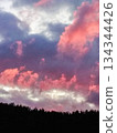 Pink clouds at sunset over dark forest dramatic sky 134344426