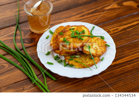 Crispy potato fritters served warm on rustic background 134344534