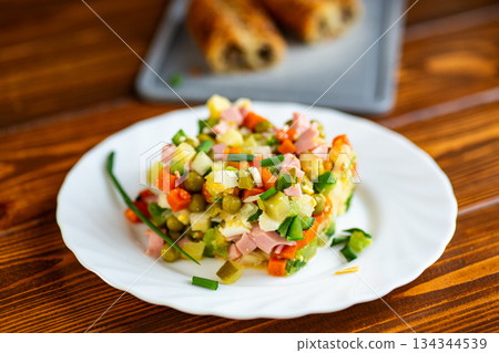 Classic olivier salad served fresh on white plate Classic olivier salad served fresh on white plate 134344539
