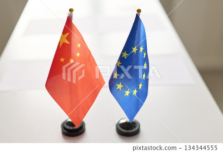 EU and China miniature flags on conference table for bilateral negotiations 134344555