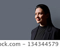 Profile headshot portrait of beautiful 40 years old woman in black wear on gray background 134344579
